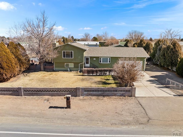 view of front of house with concrete driveway and stucco siding