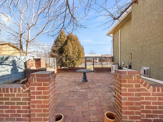 view of patio / terrace with ac unit and a fenced backyard