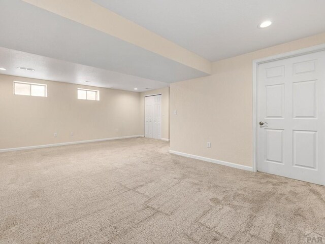 below grade area featuring carpet floors, recessed lighting, and baseboards