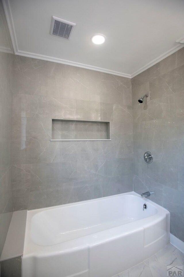 full bathroom featuring marble finish floor, bathtub / shower combination, visible vents, and crown molding