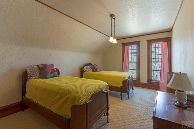 bedroom with ornamental molding, light carpet, and a textured ceiling