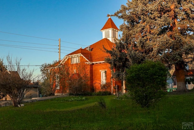 view of side of home featuring a yard