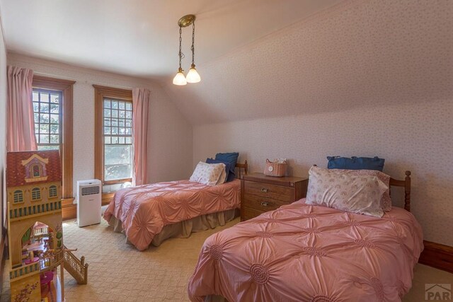 bedroom with lofted ceiling, light carpet, and wallpapered walls