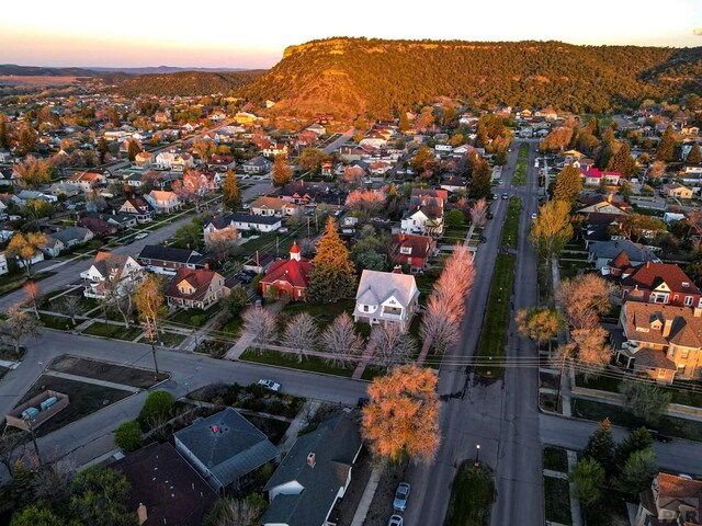 aerial view at dusk featuring a residential view