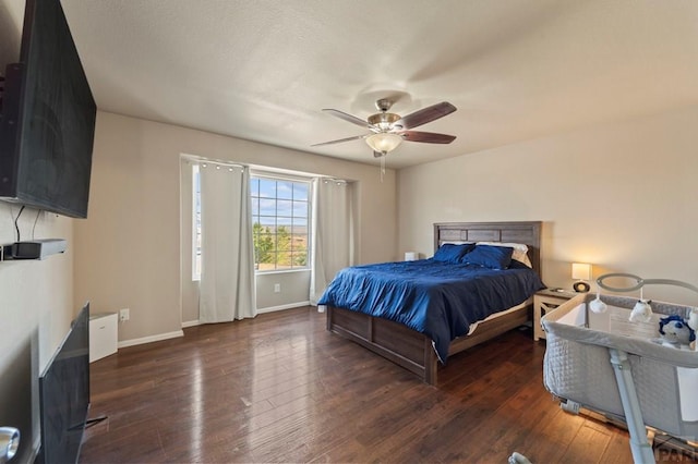 bedroom with a ceiling fan, dark wood-style flooring, and baseboards