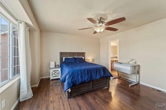 bedroom featuring visible vents, baseboards, and dark wood finished floors