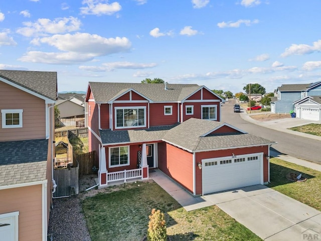 traditional home featuring a garage, a residential view, concrete driveway, and a shingled roof