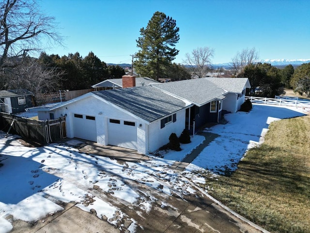 232 Saddle Rd, Trinidad, CO 81082 - view of property exterior with an attached garage, a shingled roof, driveway, and a chimney