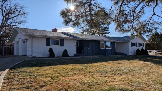 232 Saddle Rd, Trinidad, CO 81082 - ranch-style house featuring a chimney, brick siding, a garage, and driveway