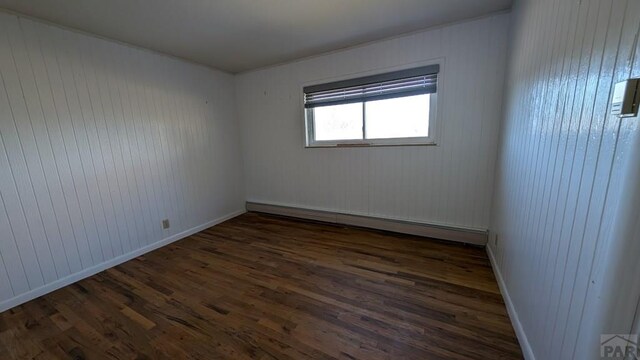 232 Saddle Rd, Trinidad, CO 81082 - empty room with baseboard heating, wood finished floors, and baseboards
