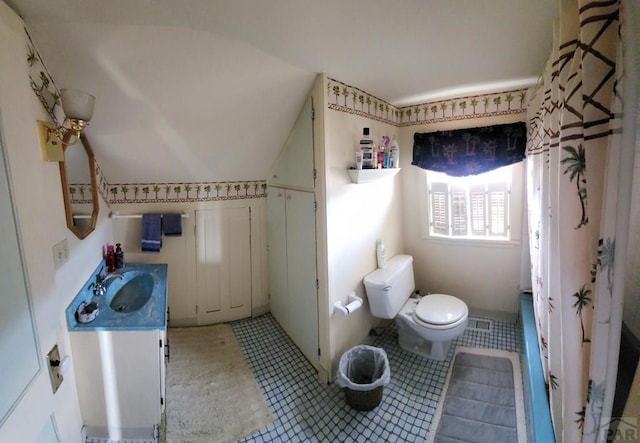 full bath featuring toilet, visible vents, vanity, vaulted ceiling, and tile patterned floors