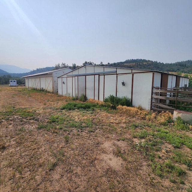 view of pole building with a mountain view