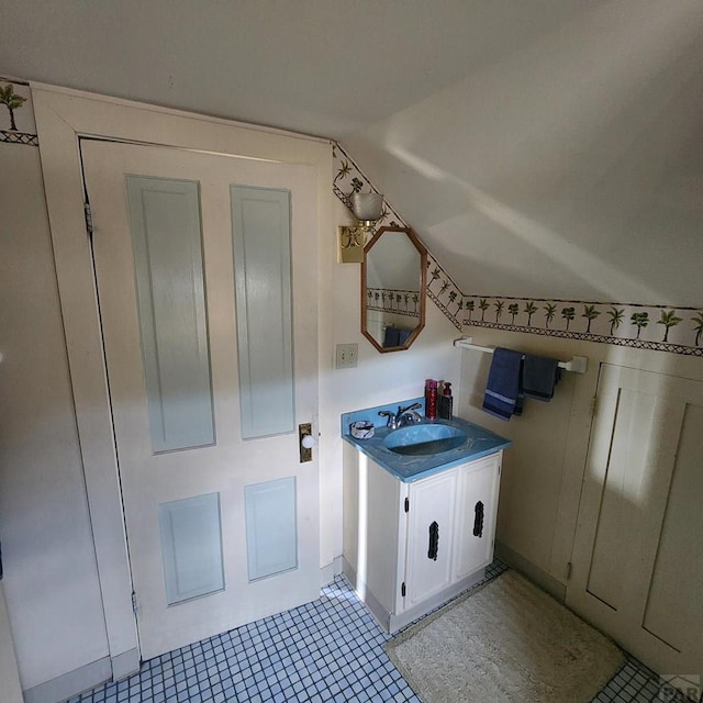 bathroom featuring vaulted ceiling, vanity, and tile patterned floors