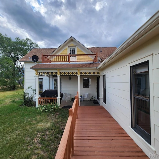 deck with a grill and a lawn