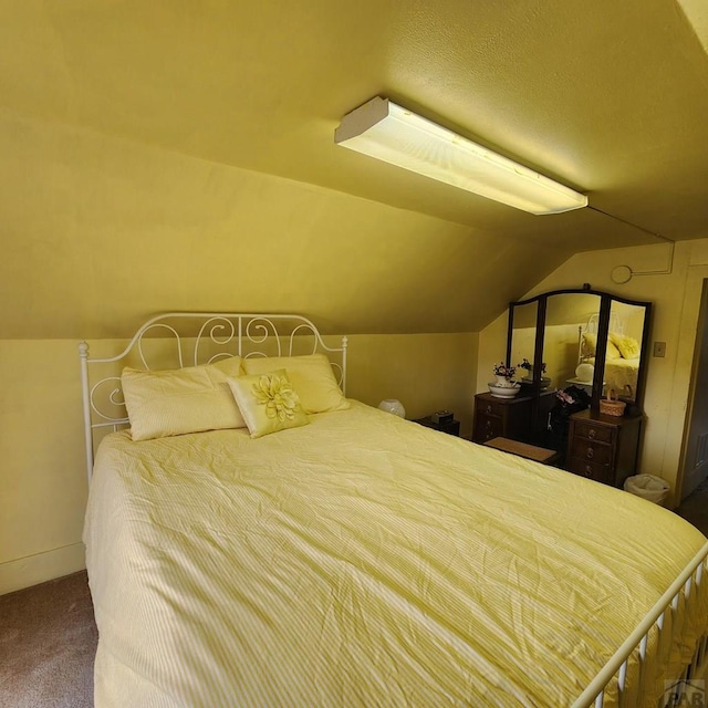 bedroom with carpet floors and lofted ceiling