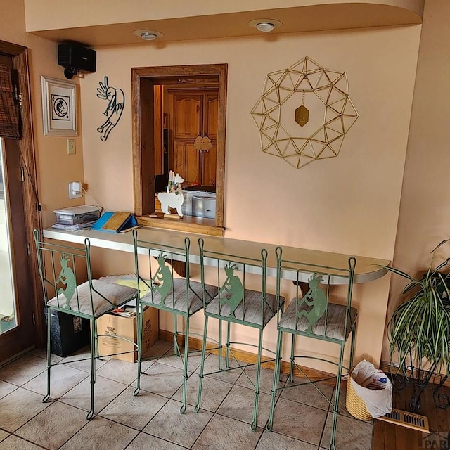 dining area with light tile patterned flooring