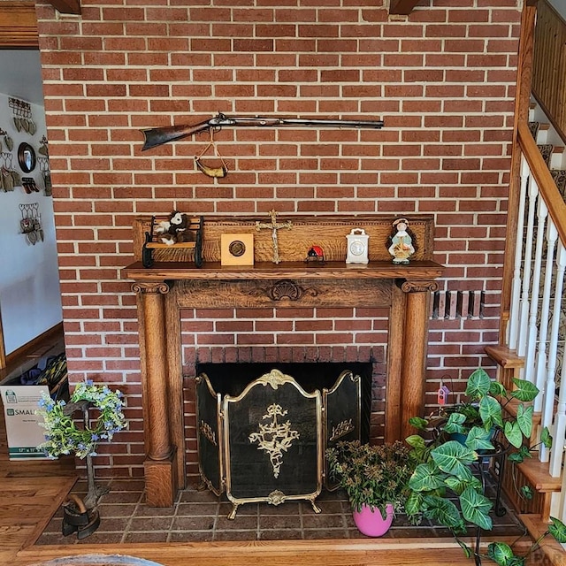 details with a fireplace and wood finished floors