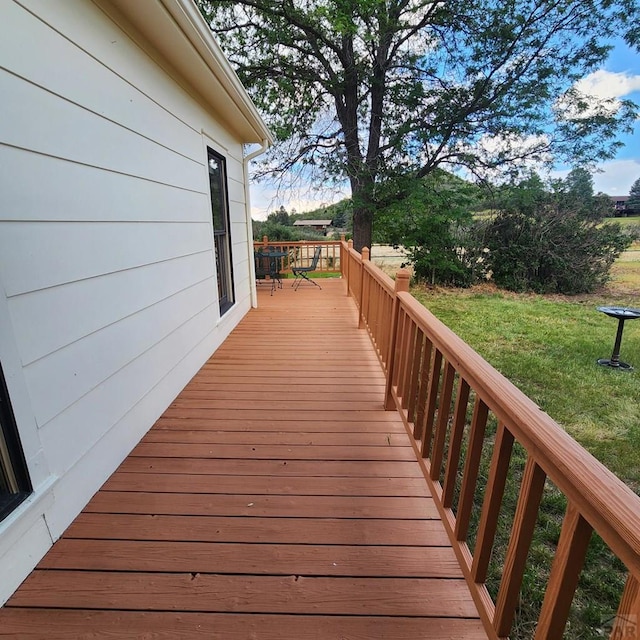 wooden deck with a lawn