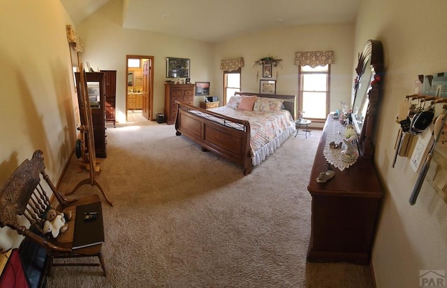 bedroom with lofted ceiling and light colored carpet