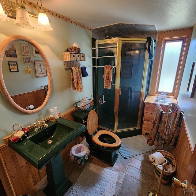 bathroom with toilet and a stall shower