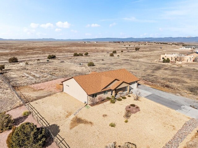 birds eye view of property featuring a mountain view and a rural view