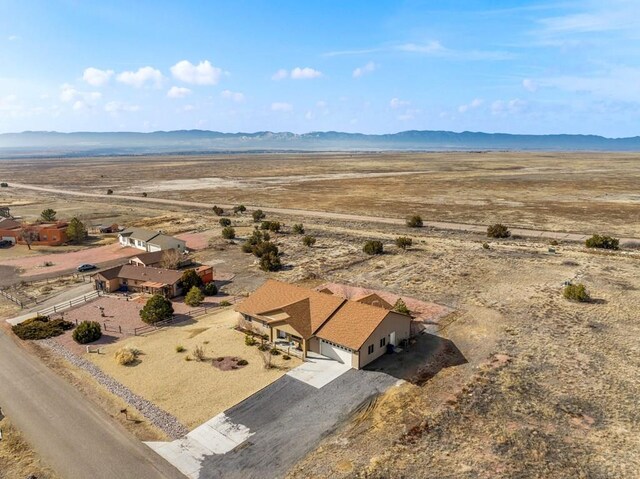 drone / aerial view featuring view of desert and a mountain view