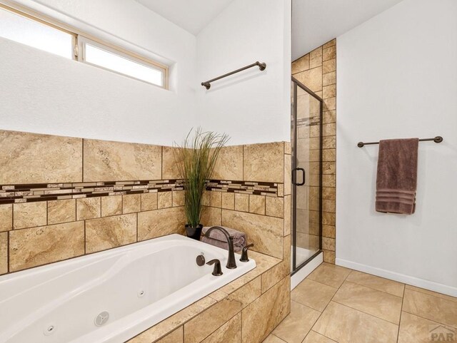 full bath with tile patterned flooring, baseboards, a shower stall, and a tub with jets