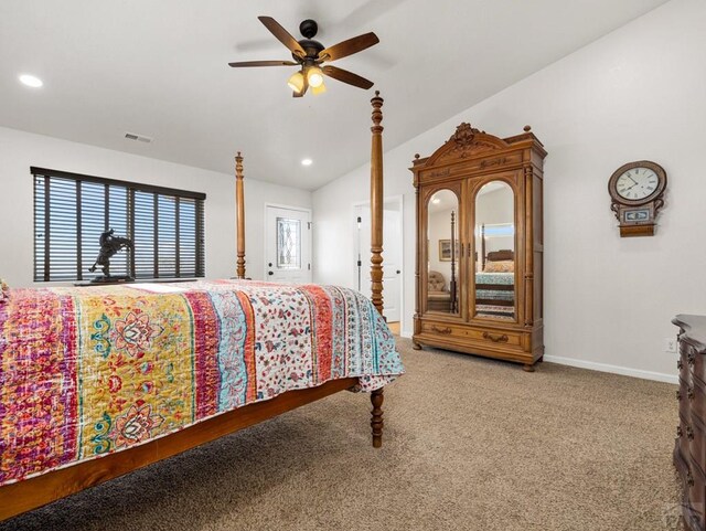 carpeted bedroom featuring lofted ceiling, baseboards, multiple windows, and visible vents