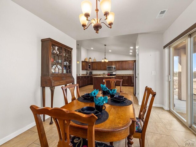 dining room featuring light tile patterned floors, baseboards, visible vents, an inviting chandelier, and vaulted ceiling