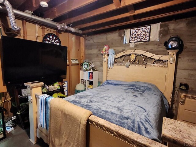 bedroom featuring concrete flooring