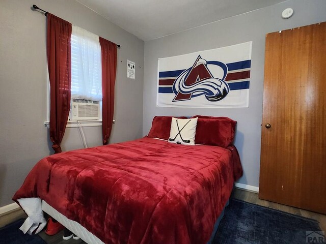 bedroom with cooling unit and baseboards