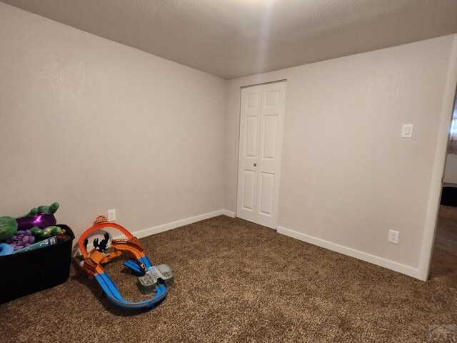 rec room with carpet floors and baseboards