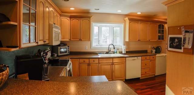 709 Cimarron Ave, La Junta, CO 81050 - kitchen featuring white appliances, a sink, dark wood-style flooring, glass insert cabinets, and dark countertops