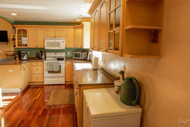 709 Cimarron Ave, La Junta, CO 81050 - kitchen featuring white appliances, a sink, dark wood-type flooring, glass insert cabinets, and light brown cabinets
