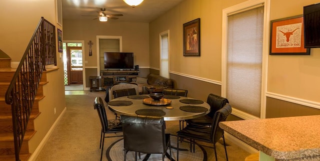 709 Cimarron Ave, La Junta, CO 81050 - dining area with a ceiling fan, stairway, and carpet flooring