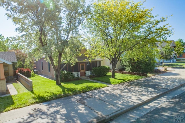 709 Cimarron Ave, La Junta, CO 81050 - view of property hidden behind natural elements with a front yard and central air condition unit