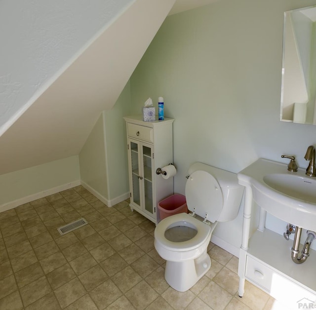 709 Cimarron Ave, La Junta, CO 81050 - bathroom featuring lofted ceiling, toilet, and tile patterned floors