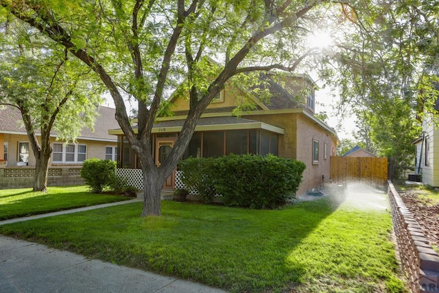 709 Cimarron Ave, La Junta, CO 81050 - view of front of house featuring a sunroom, stucco siding, and a shingled roof