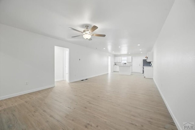 unfurnished living room with recessed lighting, ceiling fan, baseboards, and light wood-style floors