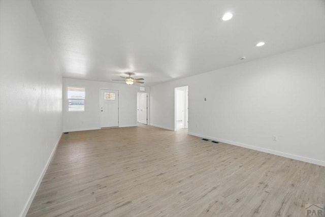 unfurnished living room featuring a ceiling fan, baseboards, recessed lighting, and light wood-type flooring