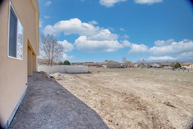 view of yard featuring fence and a residential view