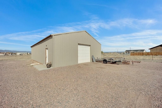 view of outbuilding with driveway and an outbuilding