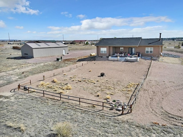 view of yard featuring an outdoor structure, a patio area, and fence