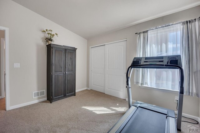 workout room featuring baseboards, carpet flooring, and visible vents