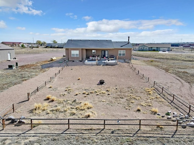 back of house featuring stucco siding, a patio area, and fence