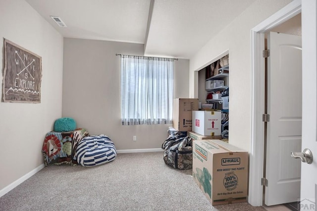 interior space with baseboards, visible vents, and carpet