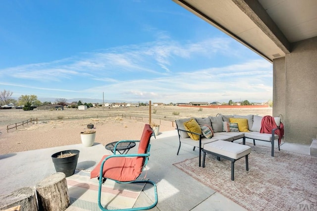 view of patio with fence and outdoor lounge area