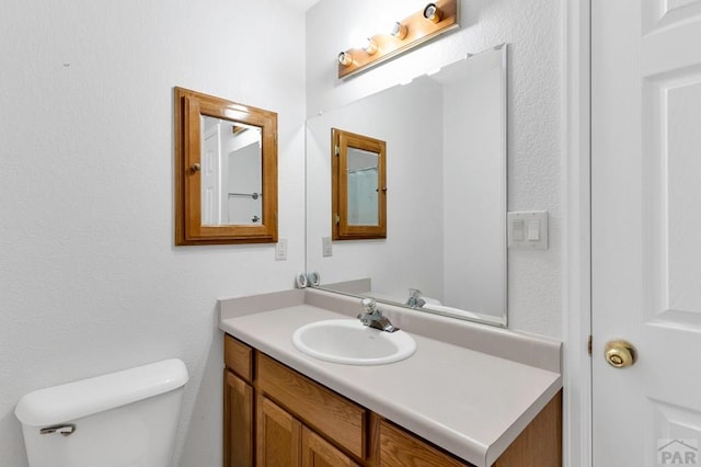 bathroom with toilet and vanity