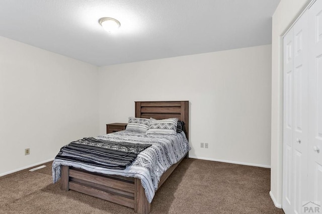 bedroom with carpet floors, visible vents, and baseboards