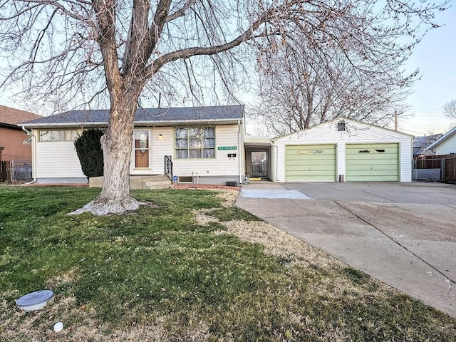 ranch-style home with a garage, a front yard, an outdoor structure, and driveway